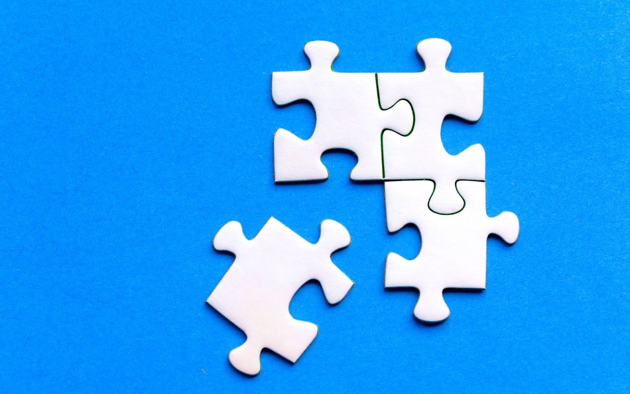 White jigsaw puzzle pieces on a blue background