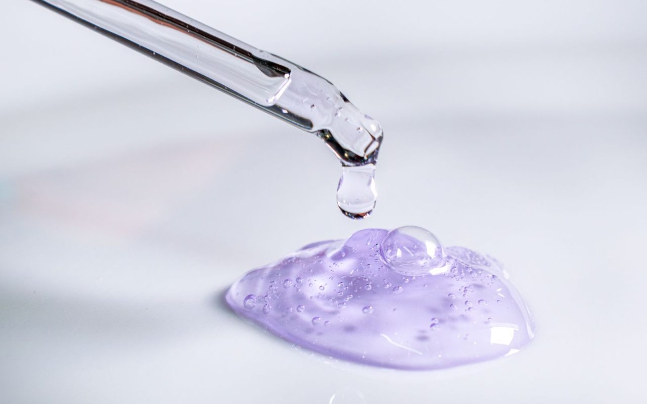 A pipette releasing a drop of gel