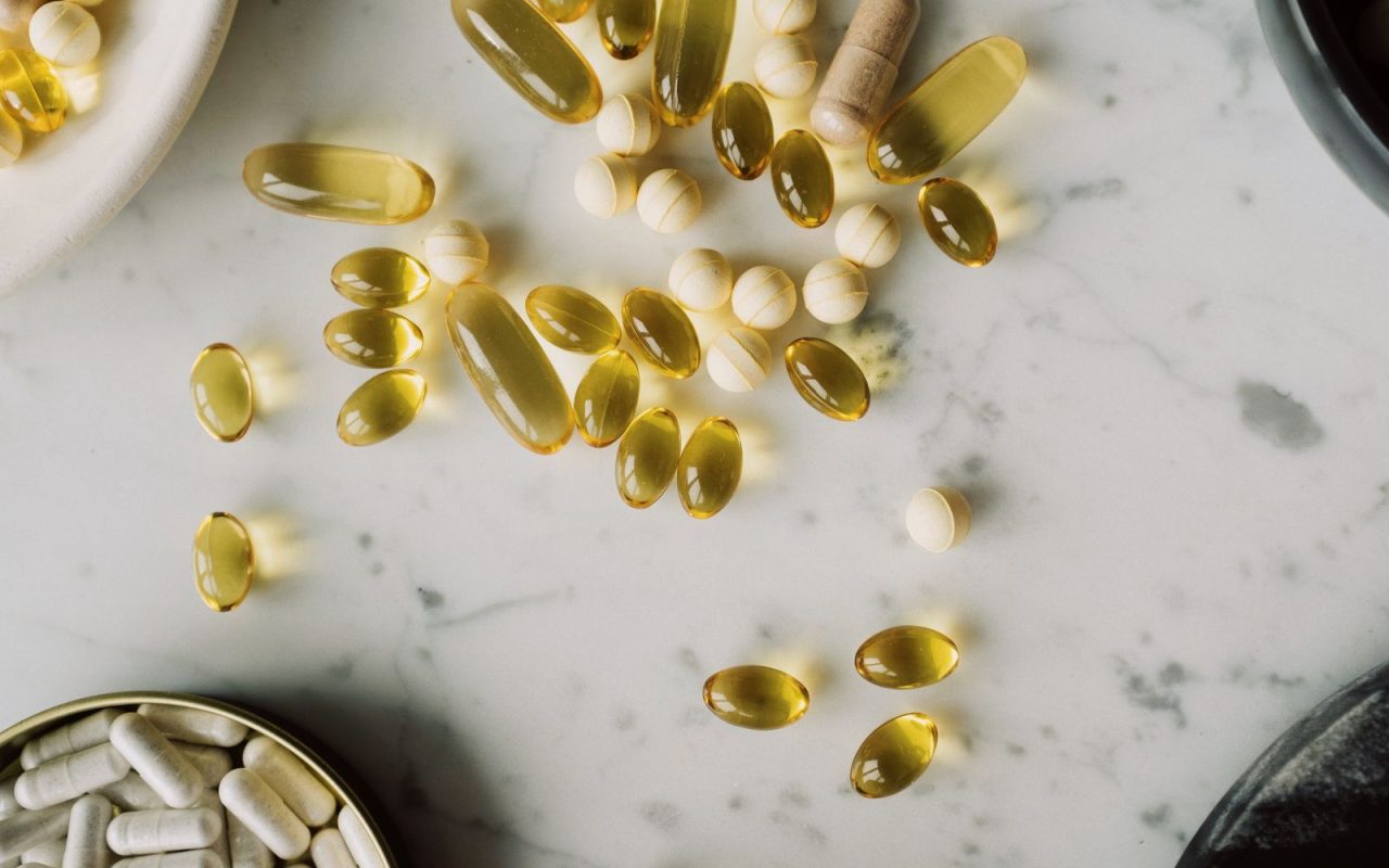 Assorted capsules on a marble tabletop