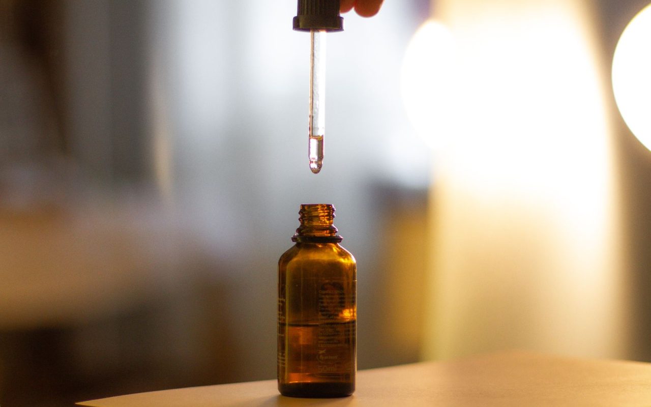 A dropper above an amber glass bottle
